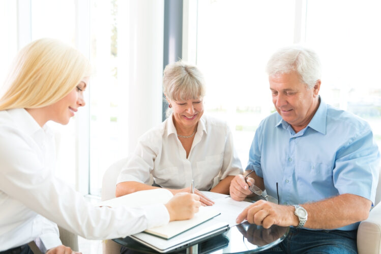 Senior couple at meeting with agent for the sale of insurance